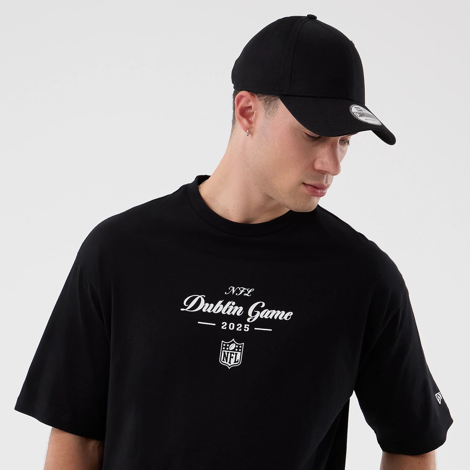The Male model is wearing Dublin Game NFL International Series Games Black Oversized T-Shirt 6