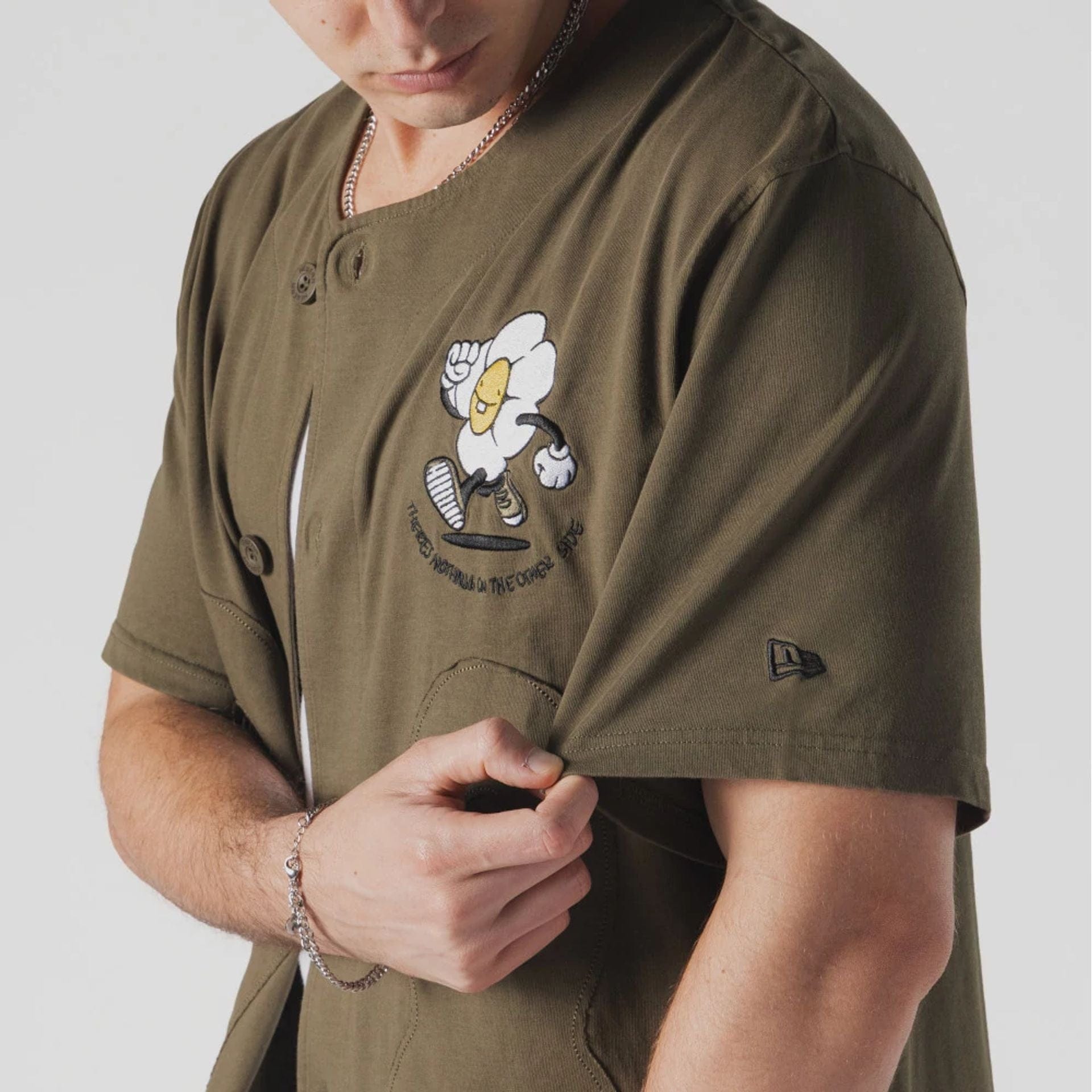 The Male model is wearing  New Era x Rodrigo Roji Flower Green Jersey  3