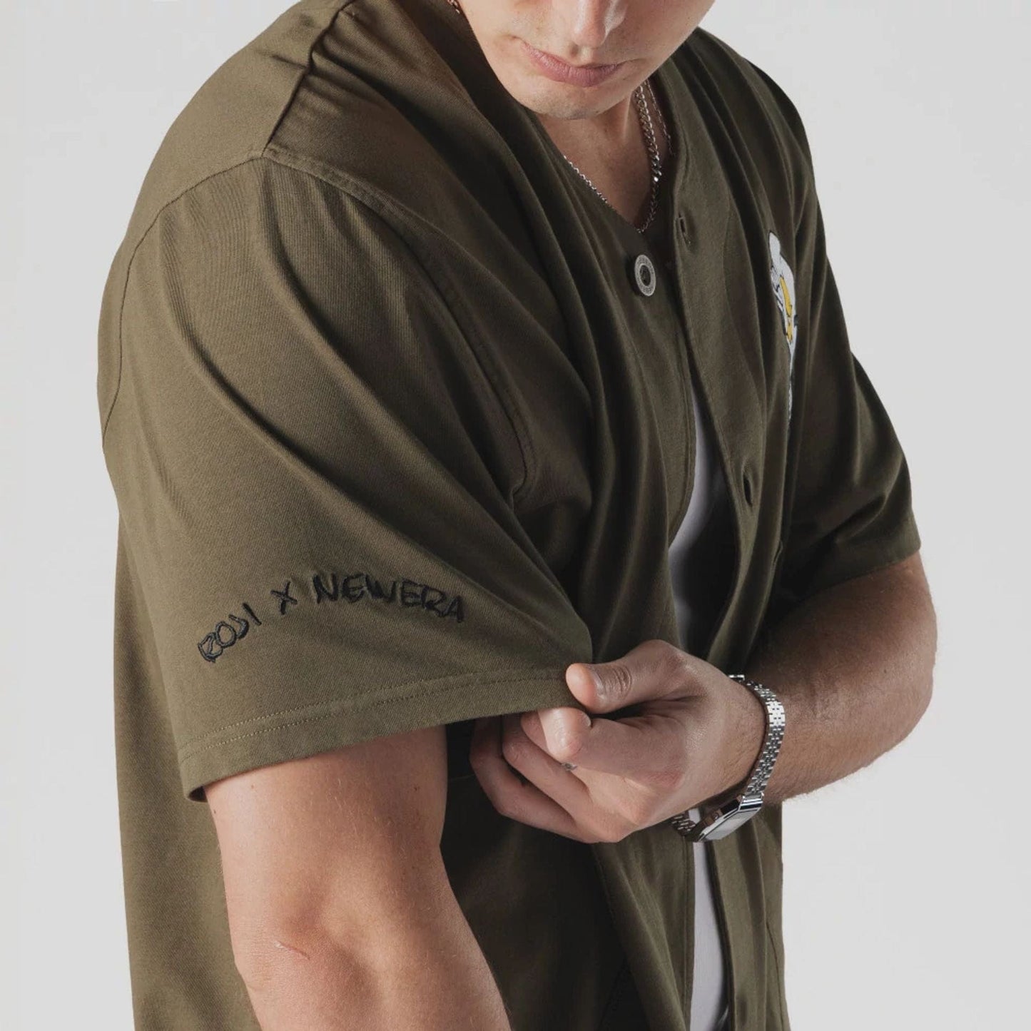 The Male model is wearing  New Era x Rodrigo Roji Flower Green Jersey  5