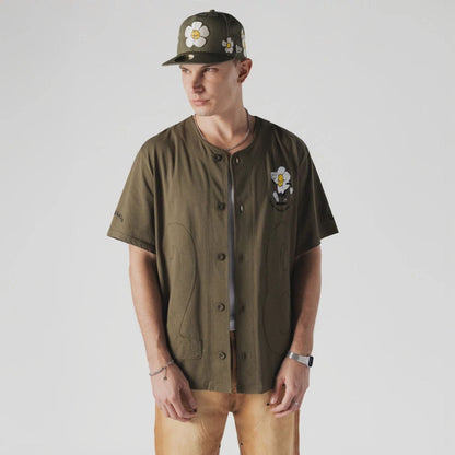 The Male model is wearing  New Era x Rodrigo Roji Flower Green Jersey  1