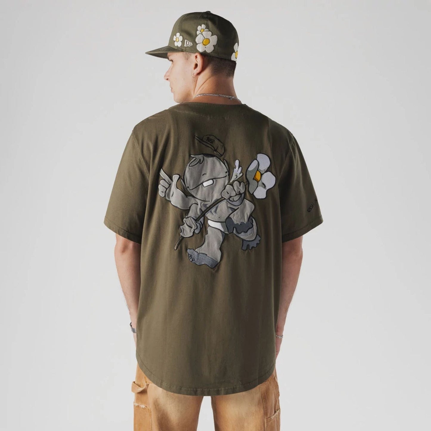 The Male model is wearing  New Era x Rodrigo Roji Flower Green Jersey  2