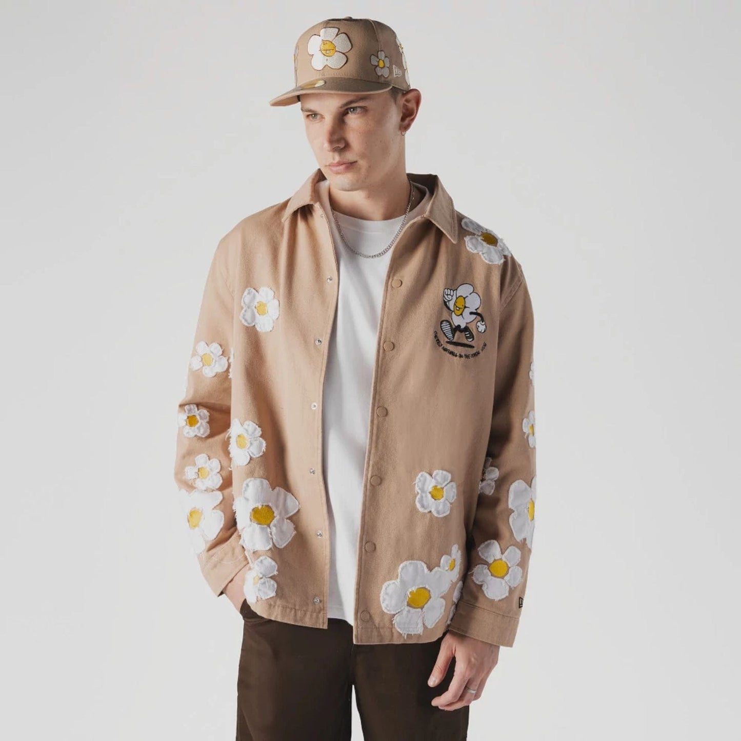 The Male model is wearing  New Era x Rodrigo Roji Flower Light Beige Jacket  1