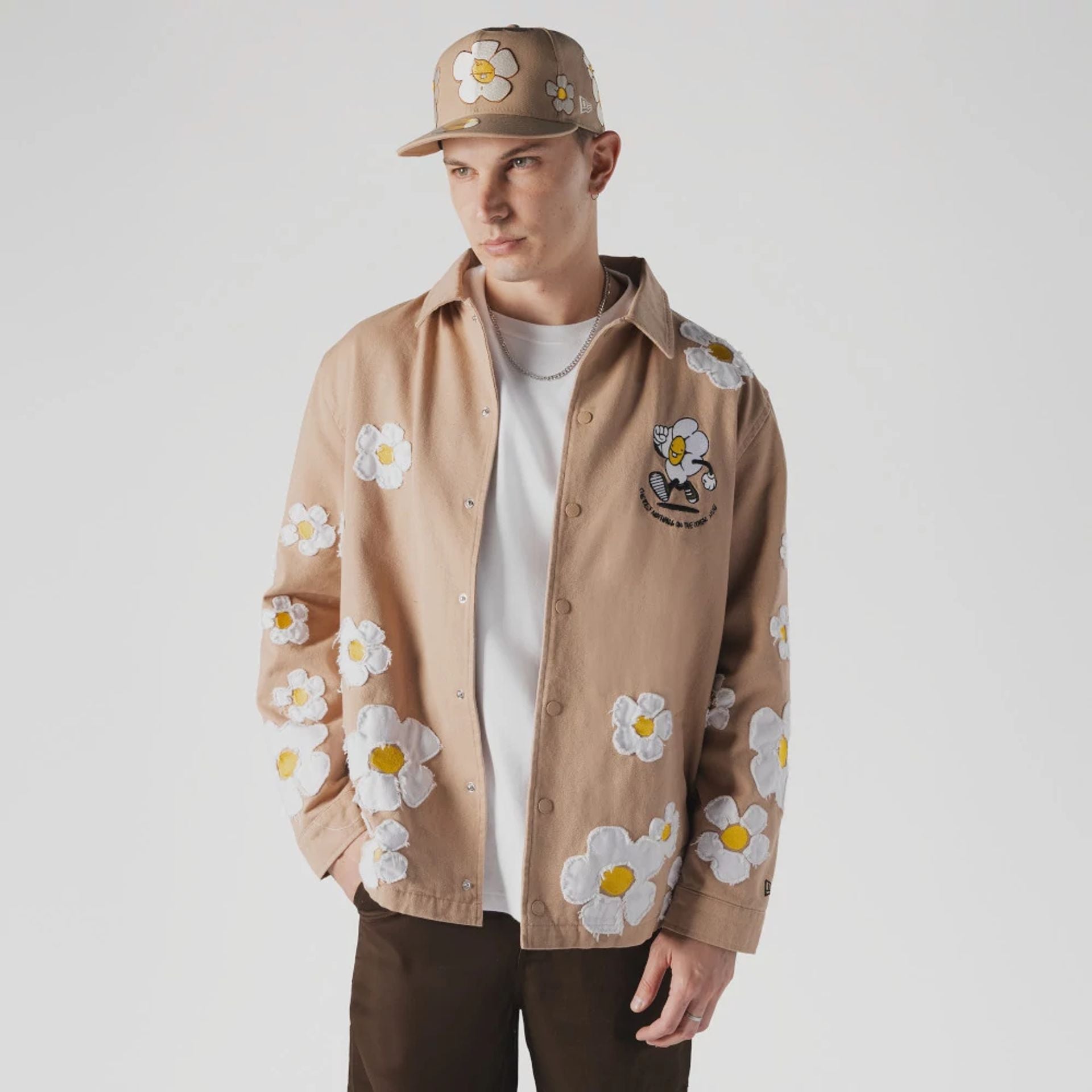 The Male model is wearing  New Era x Rodrigo Roji Flower Light Beige Jacket  1