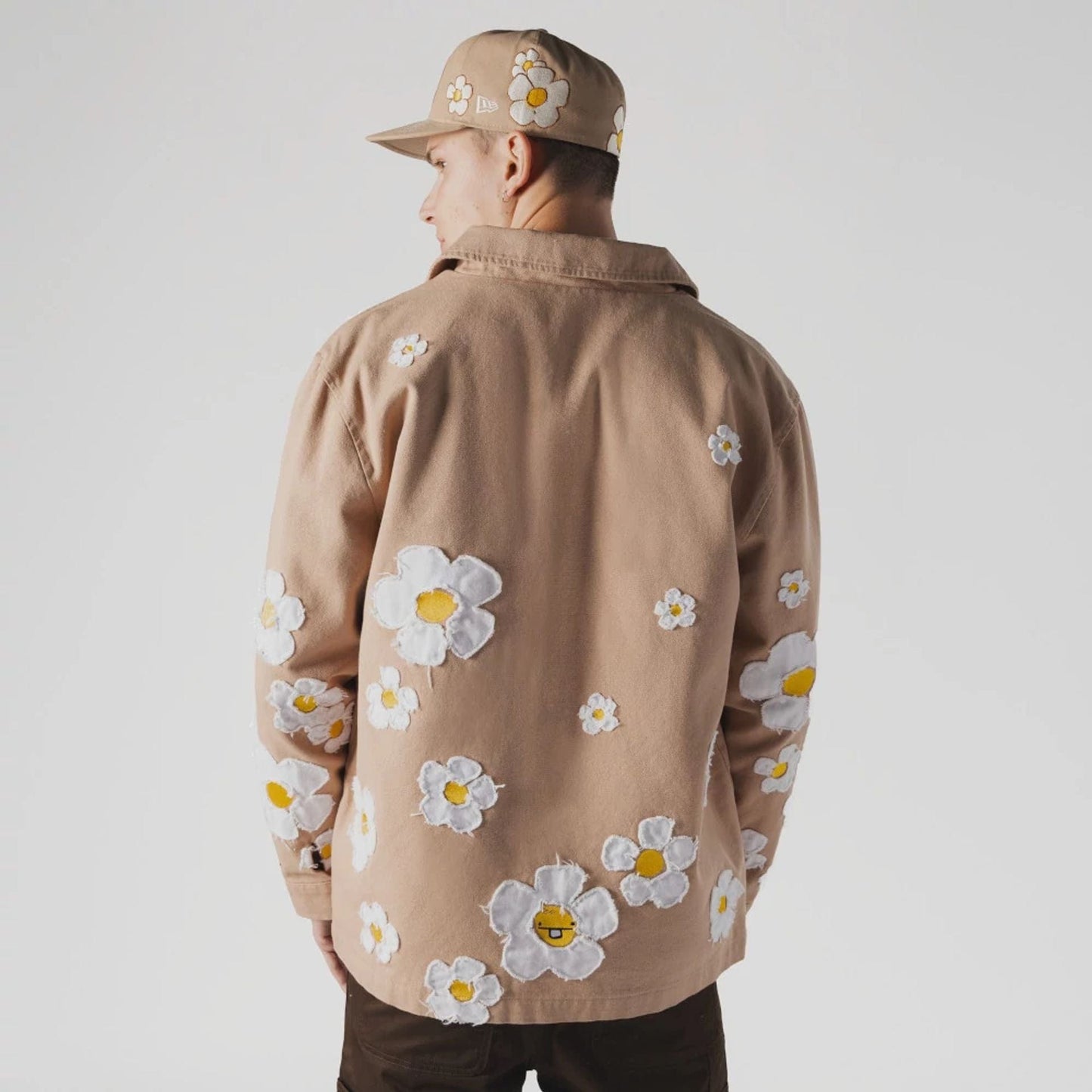 The Male model is wearing  New Era x Rodrigo Roji Flower Light Beige Jacket  2