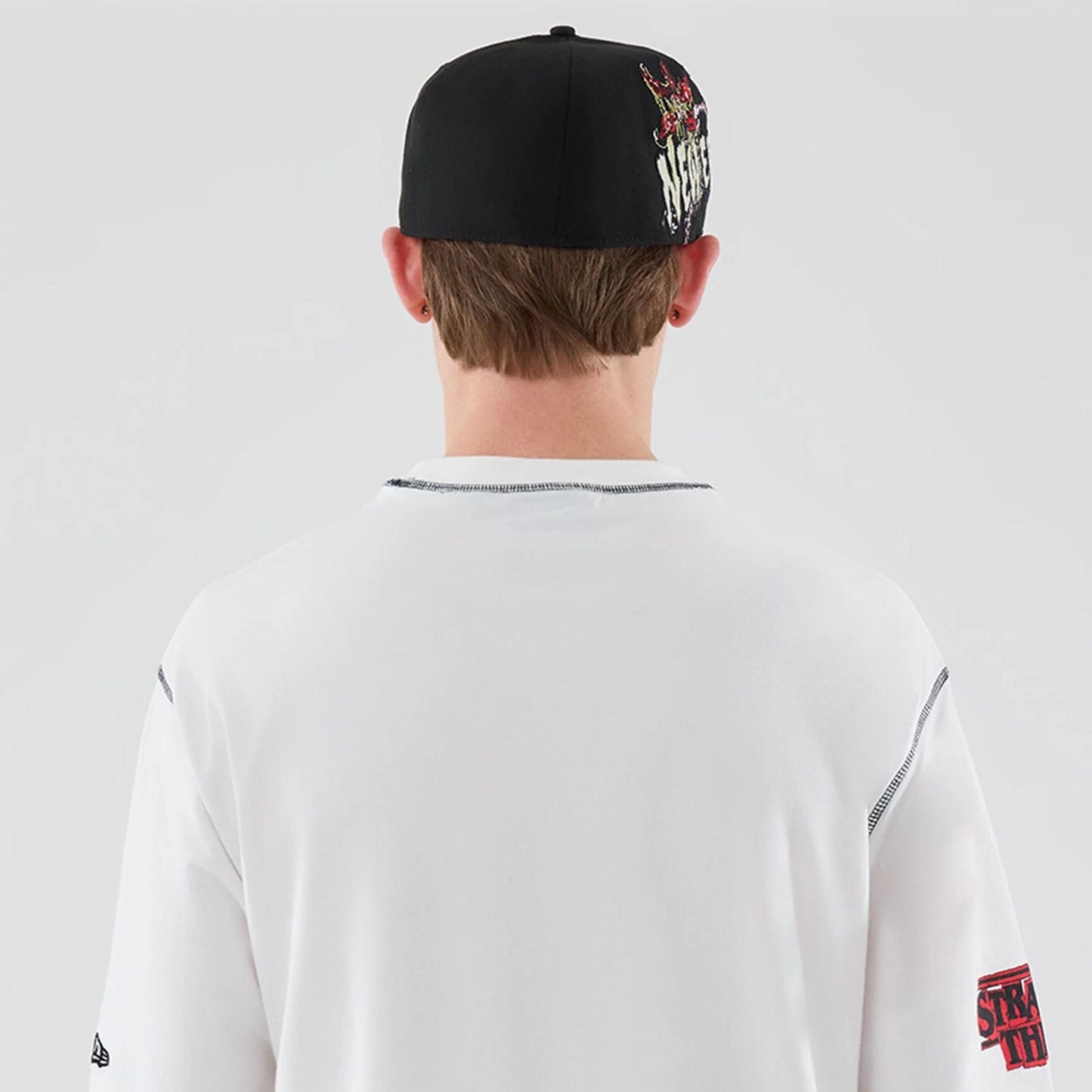 The Male model is wearing Stranger Things White Oversized T-Shirt  7