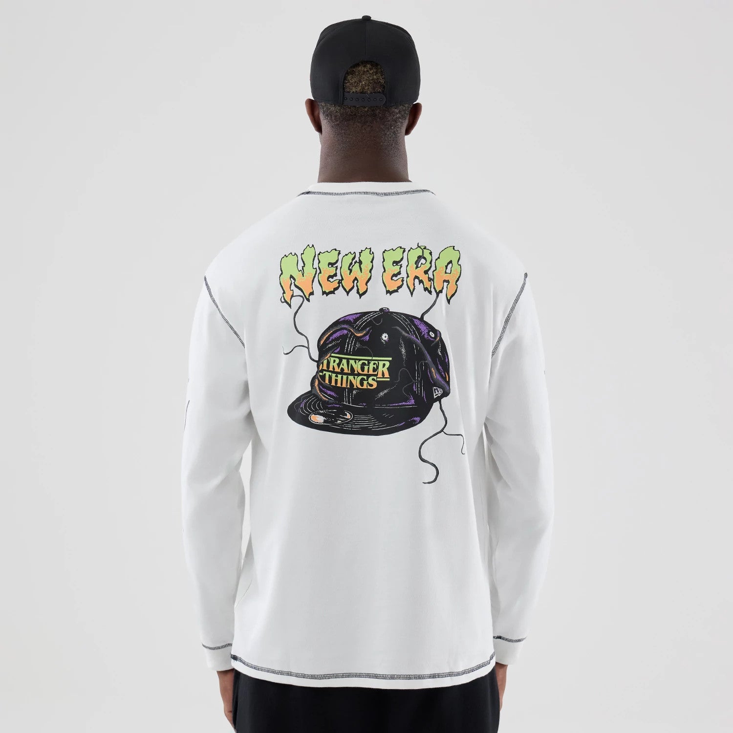 The Male model is wearing Stranger Things White Oversized Long Sleeve T-Shirt 2