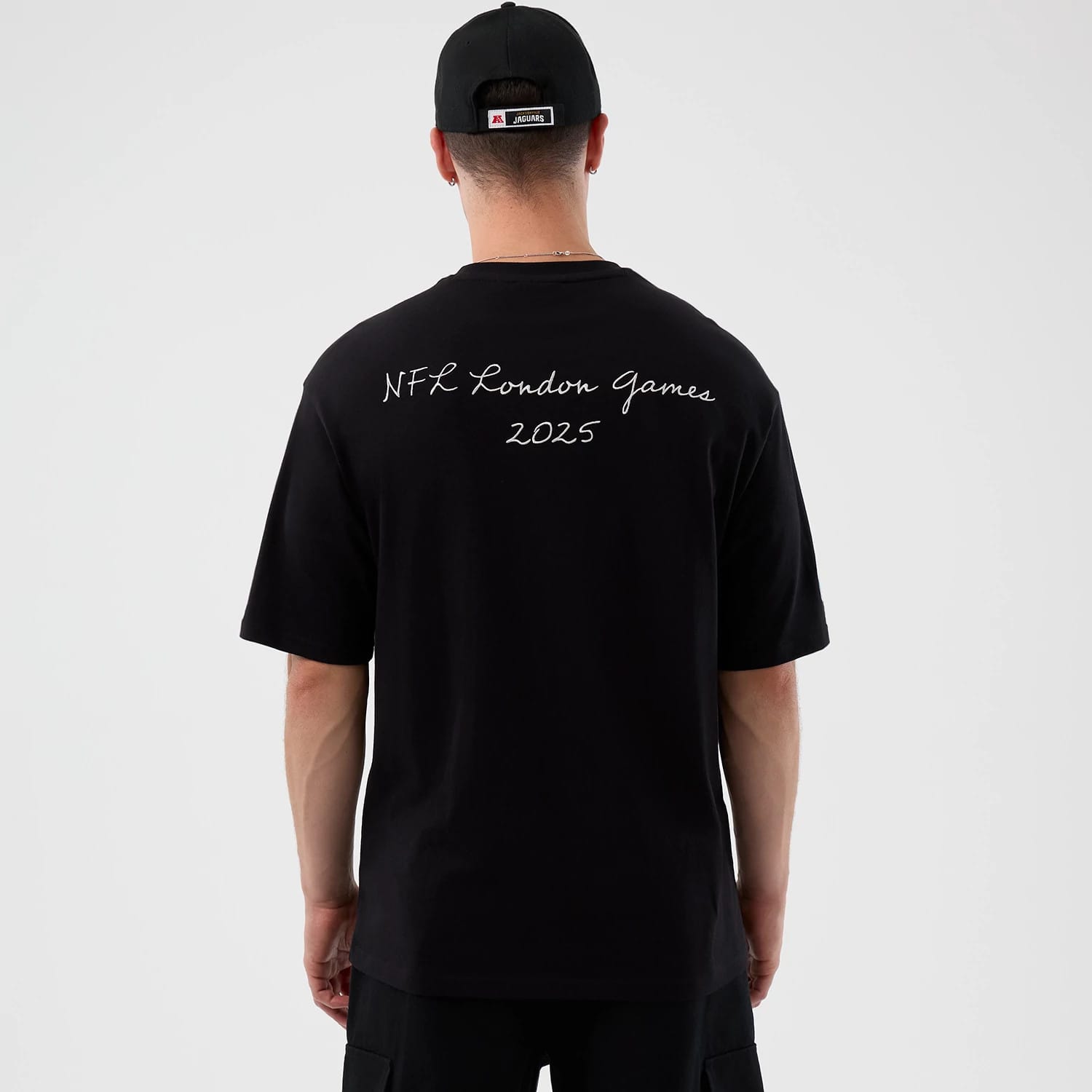 The Male model is wearing Jacksonville Jaguars NFL International Series Games Black Oversized T-Shirt 2