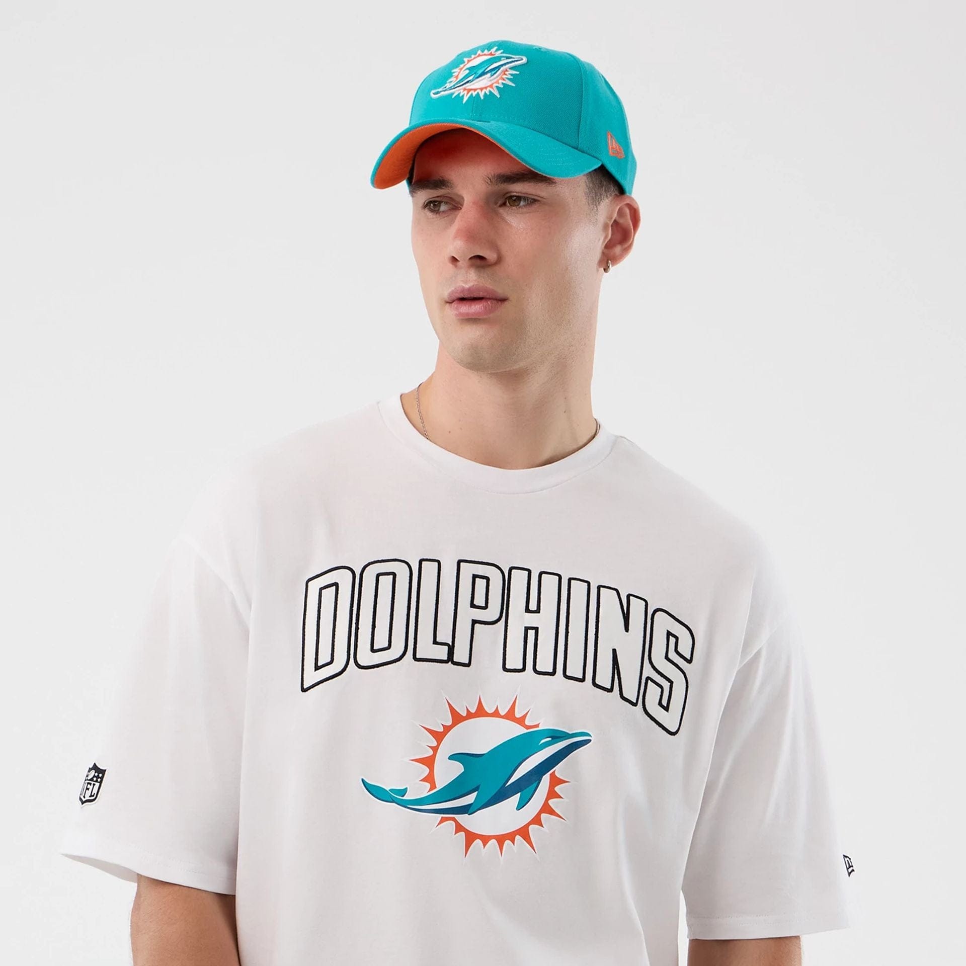The Male model is wearing Miami Dolphins NFL International Series Games White Oversized T-Shirt  6