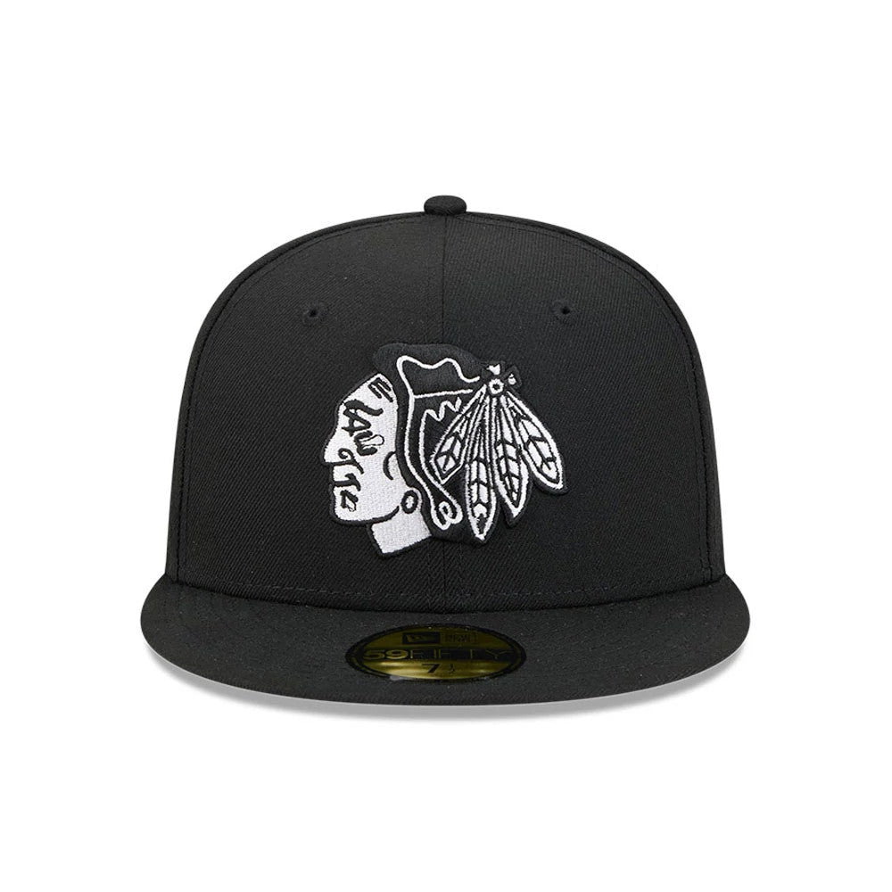 Chicago Blackhawks NHL Evergreen Black New Era 59FIFTY Fitted Cap, front view showing a white and black embroidered team logo on the structured front panels, with a flat black visor and gold 59FIFTY size sticker.