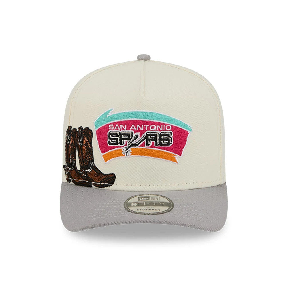 San Antonio Spurs NBA Grey New Era 9FIFTY A-Frame Snapback Adjustable Cap, front view showing embroidered team logo with colourful background on cream front panel, brown boots graphic to the left, and grey visor with 9FIFTY size sticker.