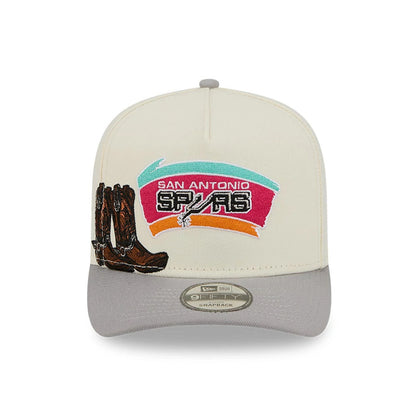 San Antonio Spurs NBA Grey New Era 9FIFTY A-Frame Snapback Adjustable Cap, front view showing embroidered team logo with colourful background on cream front panel, brown boots graphic to the left, and grey visor with 9FIFTY size sticker.