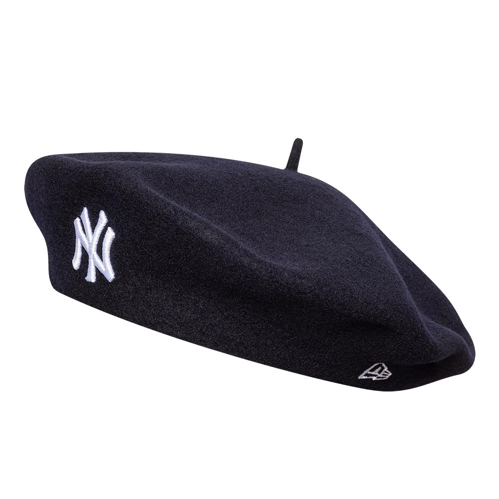 New Era New York Yankees Womens MLB Wool Navy Beret, side view showing the white embroidered NY logo on the front and the New Era flag logo embroidered on the side, with a classic beret stem on top.