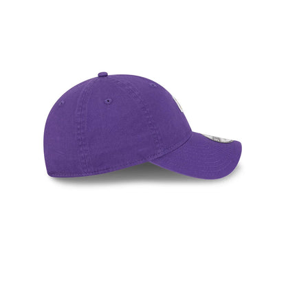 LA Lakers NBA All Star Game 2026 Purple New Era 9TWENTY Adjustable Cap, side view showing the unstructured purple crown with embroidered eyelets, a curved visor, and a silver size sticker on the top.