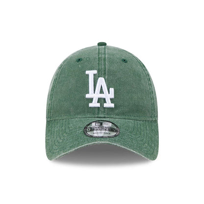 LA Dodgers MLB Overwash Dark Green New Era 9TWENTY Adjustable Cap, front view showing the white raised embroidered LA logo on the unstructured washed dark green crown with a curved visor and 9TWENTY size sticker.