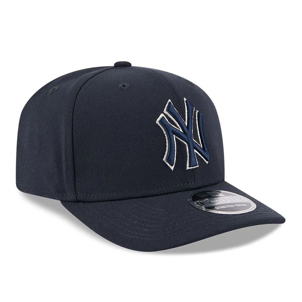 New York Yankees MLB Navy New Era 9SEVENTY Stretch Snap Adjustable Cap, three-quarter view showing the raised embroidered white-outlined NY logo on the front panel, with a curved navy visor and a 9SEVENTY size sticker.