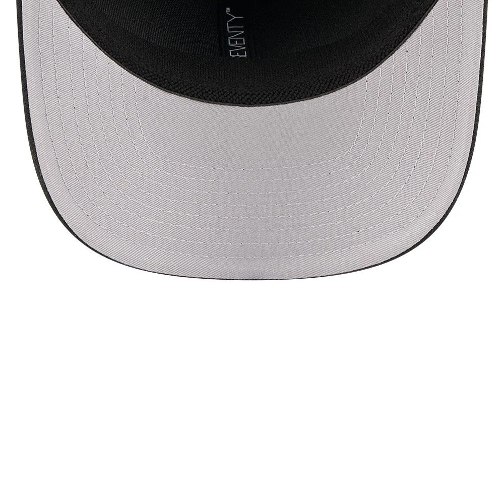 New Era Flawless Black 9SEVENTY Stretch Snap Adjustable Cap, inside view showing the light grey undervisor with detailed stitching, black sweatband and the New Era logo repeating along the black taping.