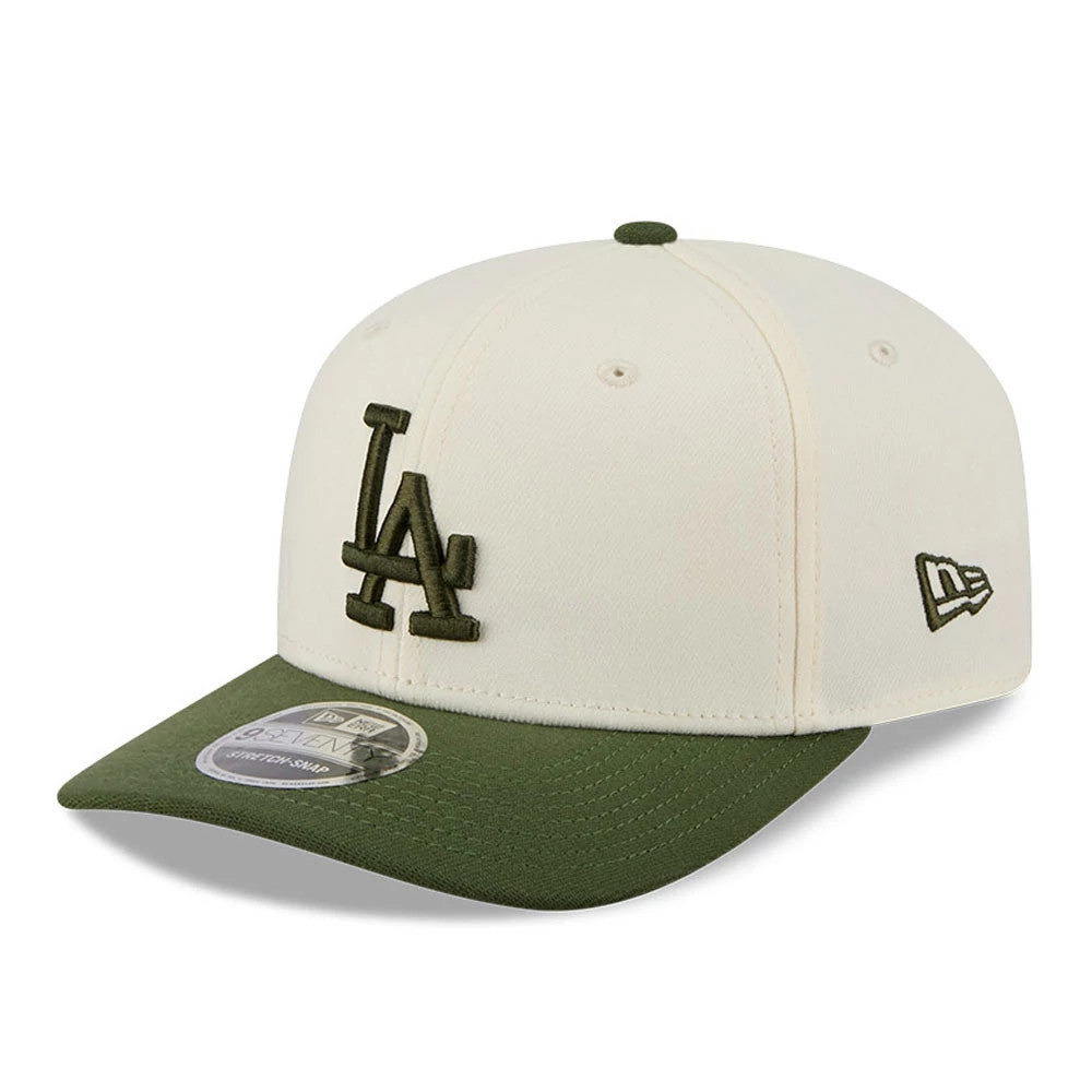 LA Dodgers MLB Rifle Green New Era 9SEVENTY Stretch Snap Adjustable Cap, three-quarter view showing the green raised embroidered LA logo on the front panel, green visor with 9SEVENTY size sticker, and New Era flag logo on the left side.