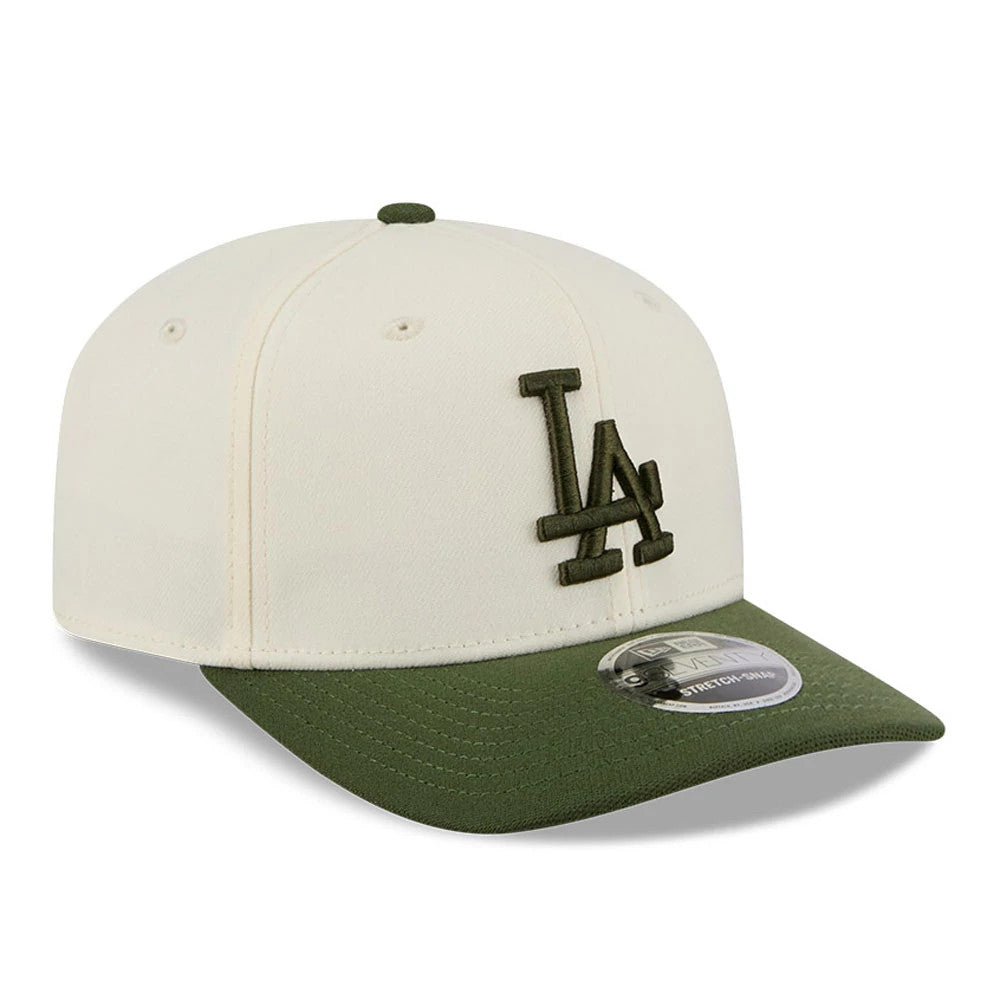 LA Dodgers MLB Rifle Green New Era 9SEVENTY Stretch Snap Adjustable Cap, three-quarter view showing the green embroidered LA logo on the cream front panel, with a matching green visor and a 9SEVENTY size sticker.