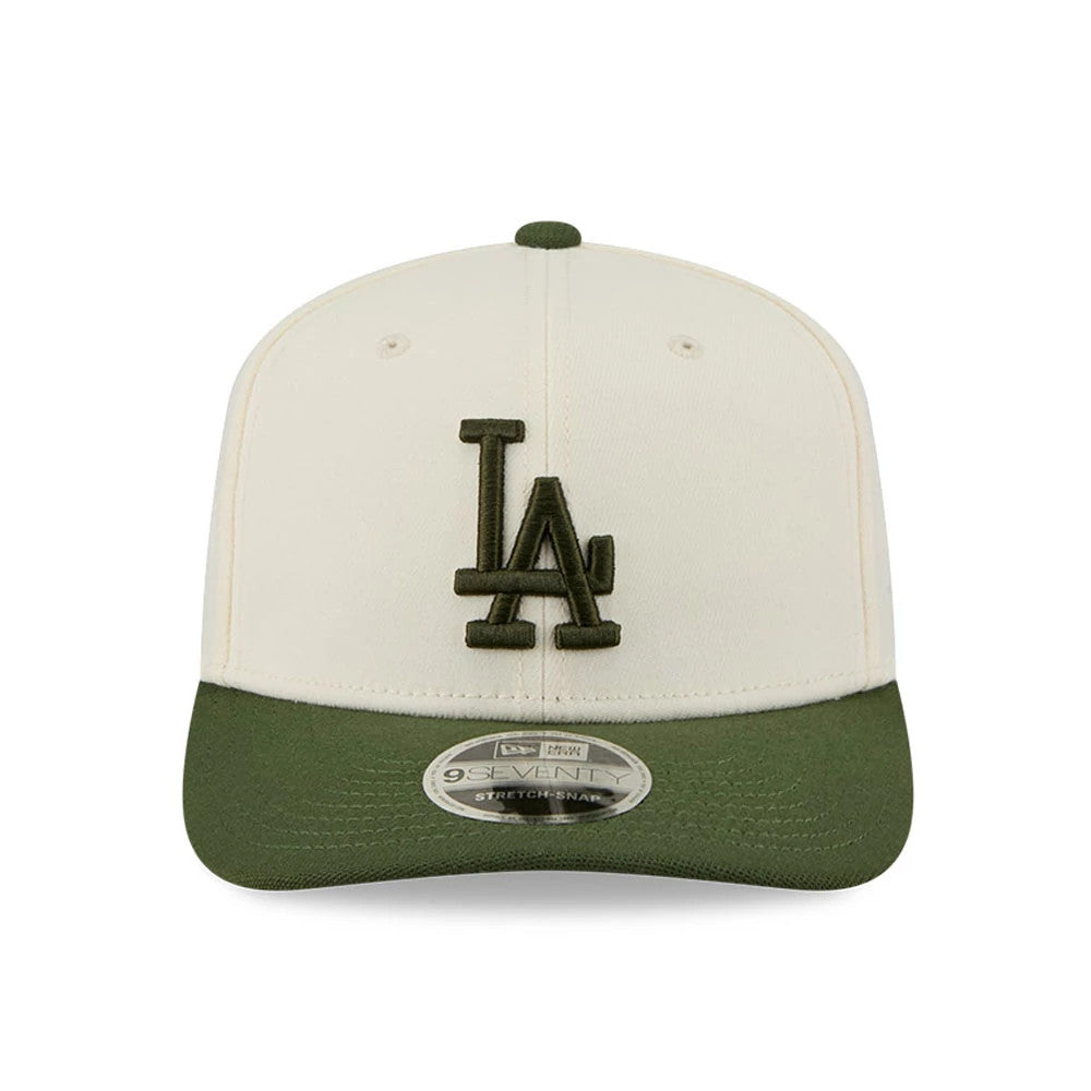 LA Dodgers MLB Rifle Green New Era 9SEVENTY Stretch Snap Adjustable Cap, front view showing a dark green embroidered LA logo on the cream front panel, green curved visor and 9SEVENTY size sticker on the visor.