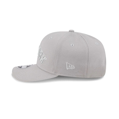 Pictured is this MLB Script New York Yankees 9SEVENTY Stretch Snap cap in grey. 4