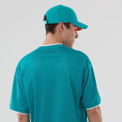 The model is wearing this NFL Mesh Miami Dolphins Oversized T-Shirt in turquoise. 7
