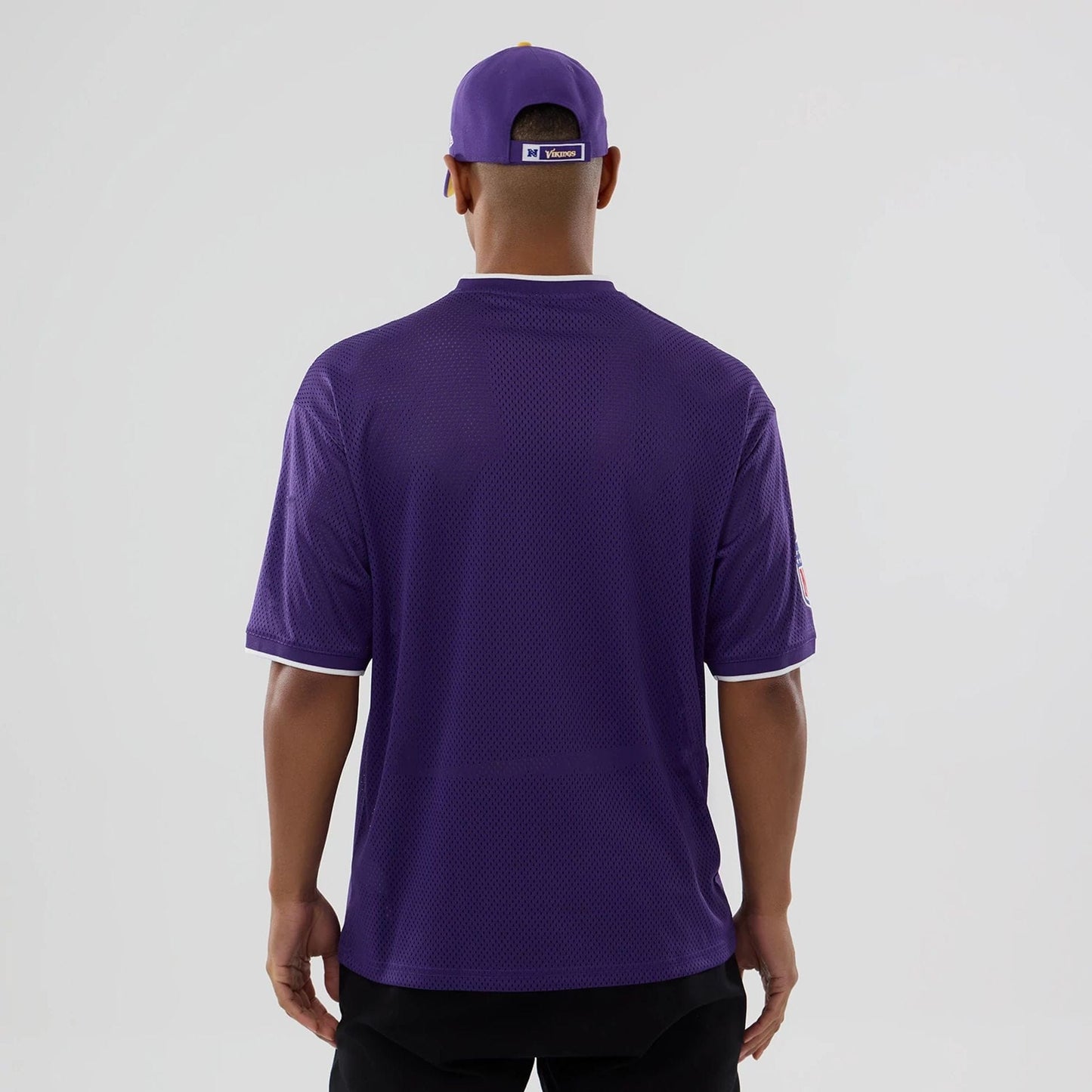 The model is wearing this NFL Mesh Minnesota Vikings Oversized T-Shirt in purple. 2