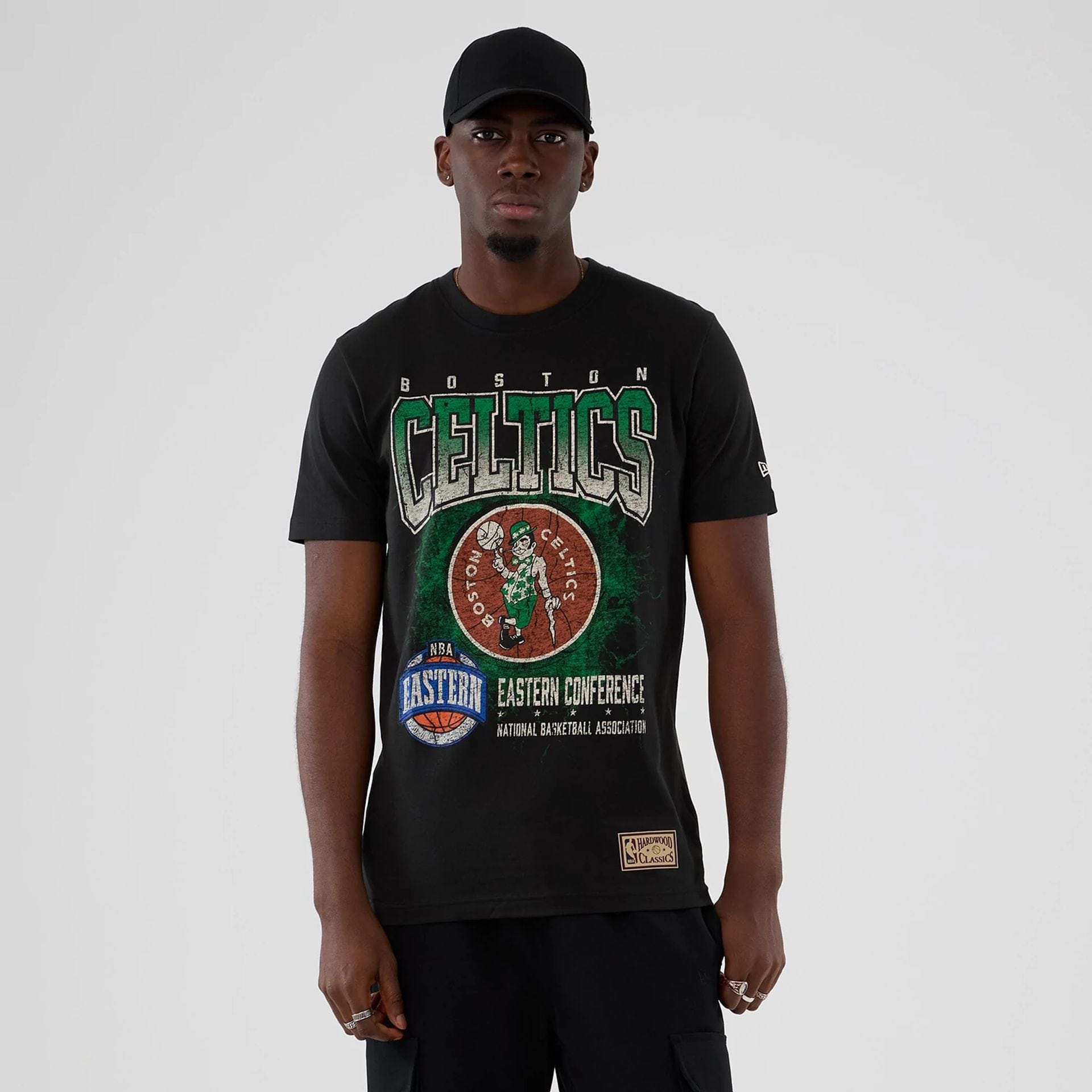 The model is wearing this NBA Hardwood Classic Boston Celtics T-Shirt in black. 1