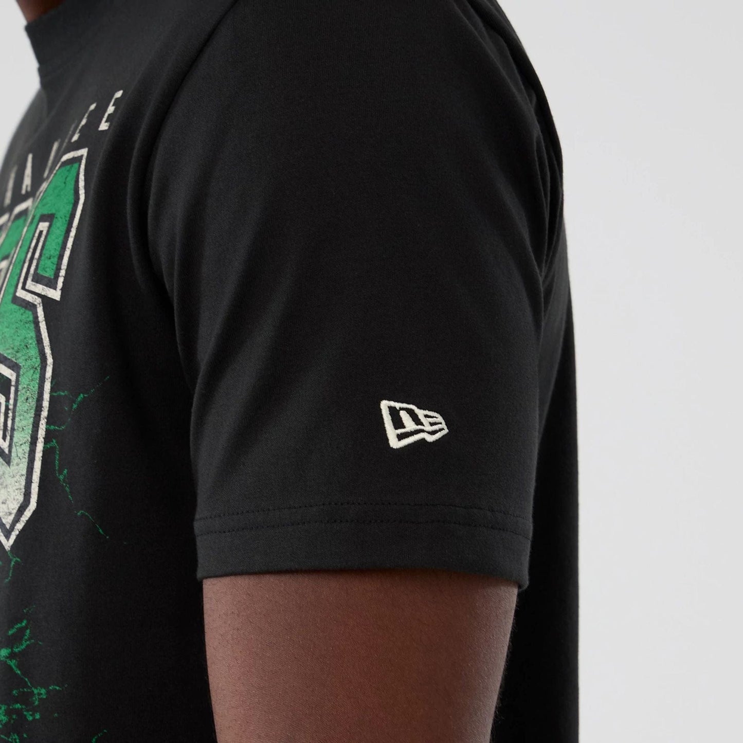 The model is wearing this NBA Hardwood Classic Milwaukee Bucks T-Shirt in black. 4