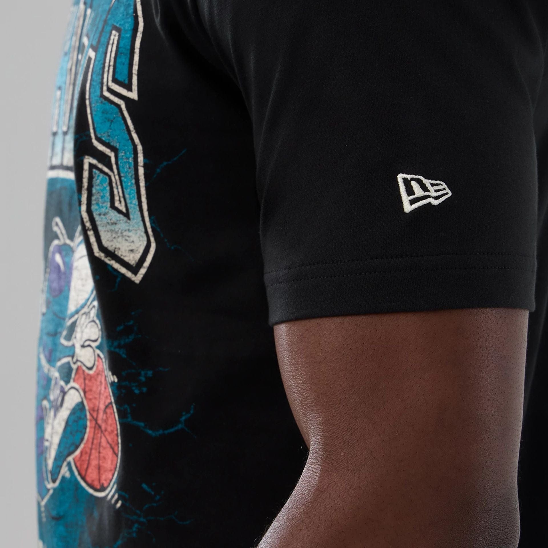 The model is wearing this NBA Hardwood Classic Charlotte Hornets T-Shirt in black. 4