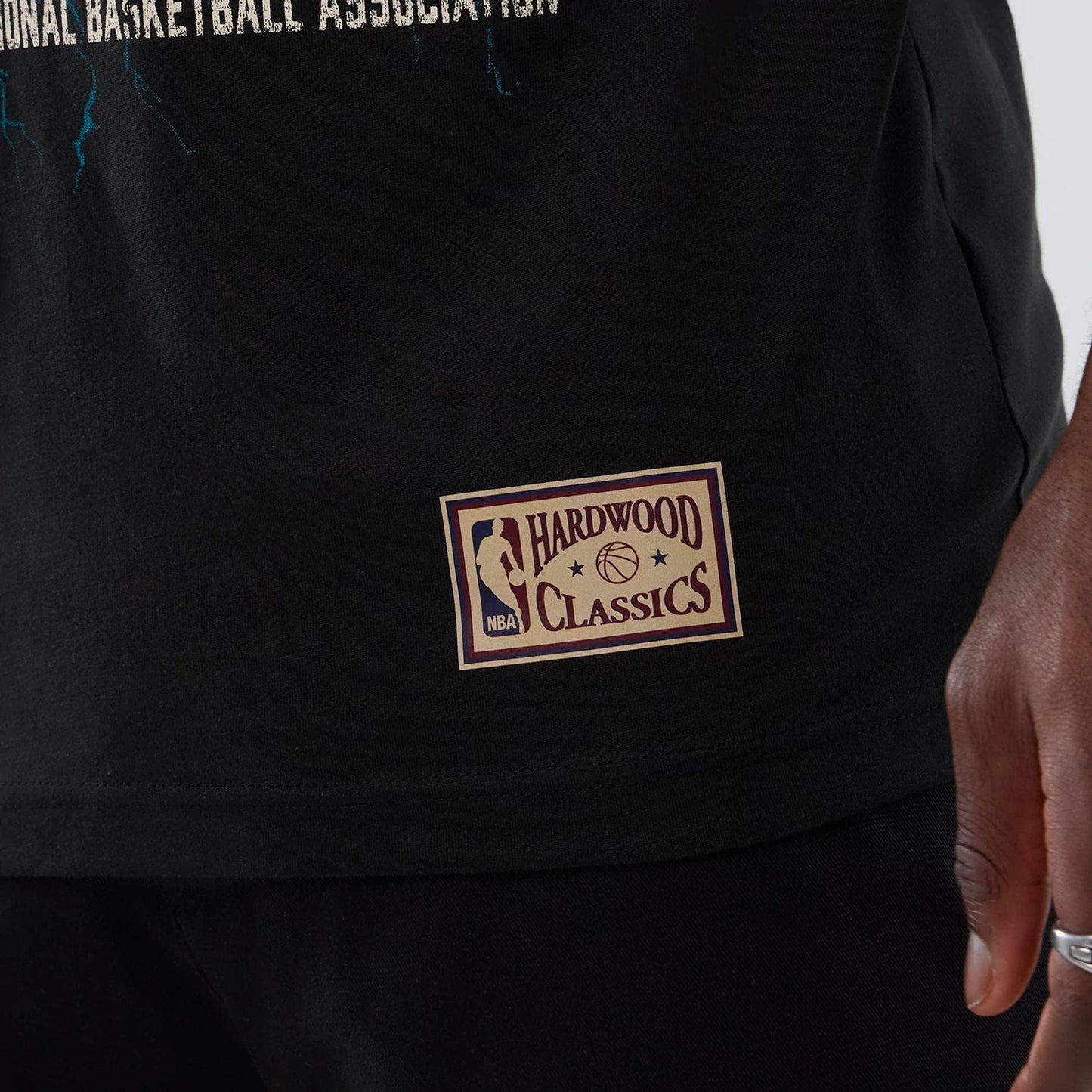 The model is wearing this NBA Hardwood Classic Charlotte Hornets T-Shirt in black. 5