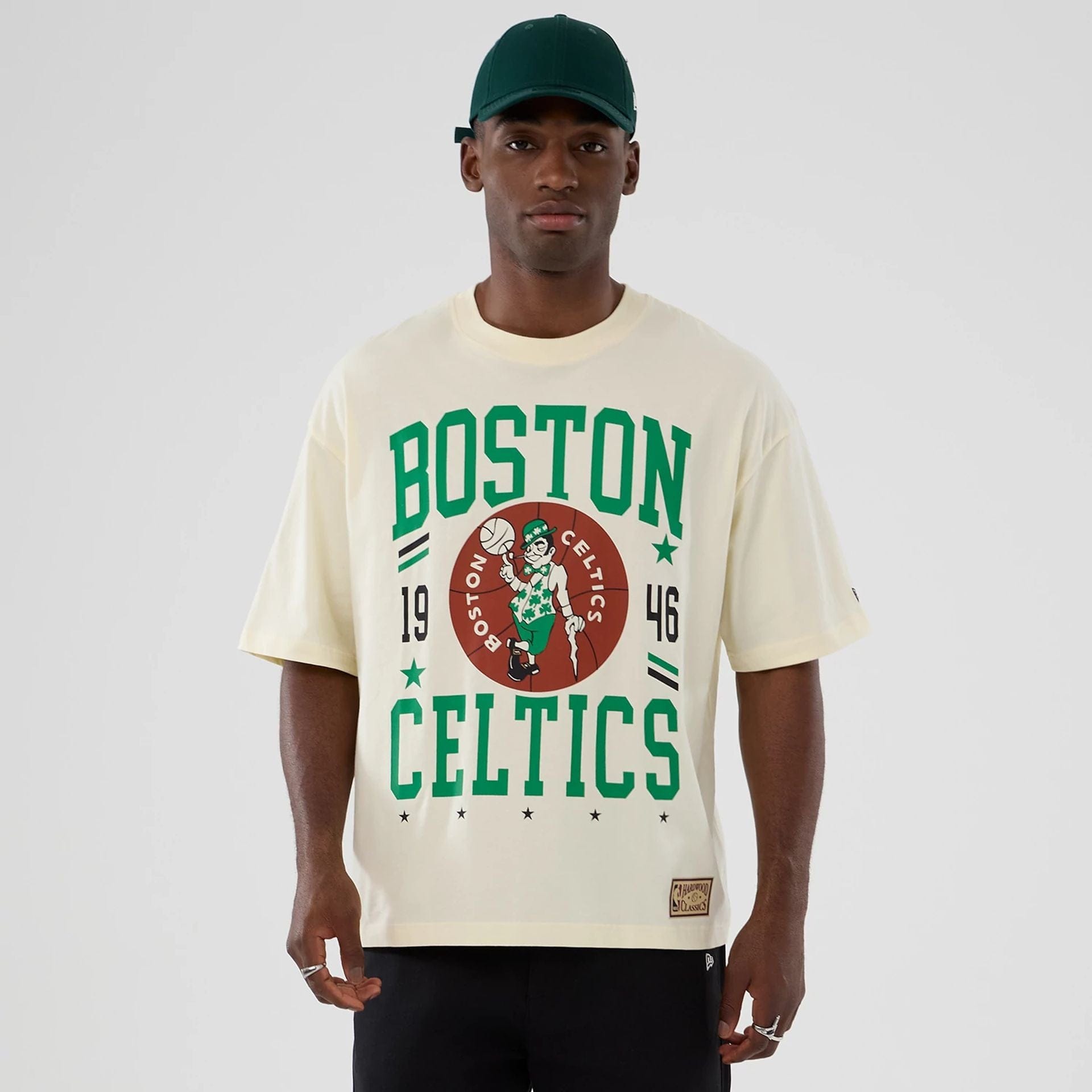 The model is wearing this NBA Hardwood Classic Boston Celtics T-Shirt in cream. 1