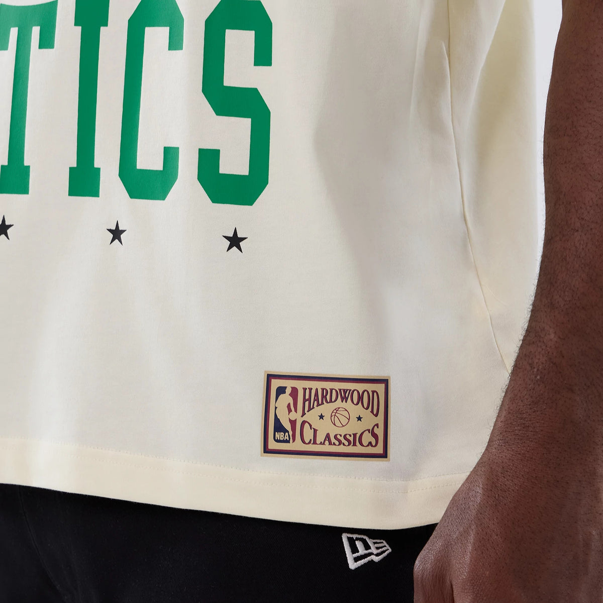 The model is wearing this NBA Hardwood Classic Boston Celtics T-Shirt in cream. 5