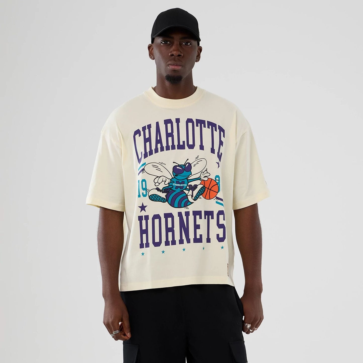 The model is wearing this NBA Hardwood Classic Charlotte Hornets T-Shirt in cream. 1