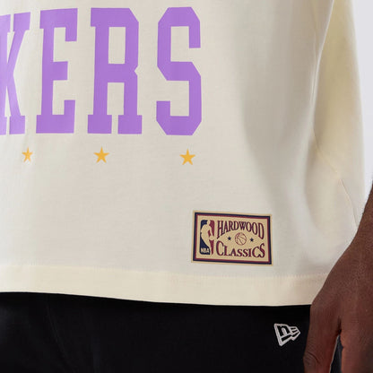 The model is wearing this NBA Hardwood Classic LA Lakers T-Shirt in cream. 5