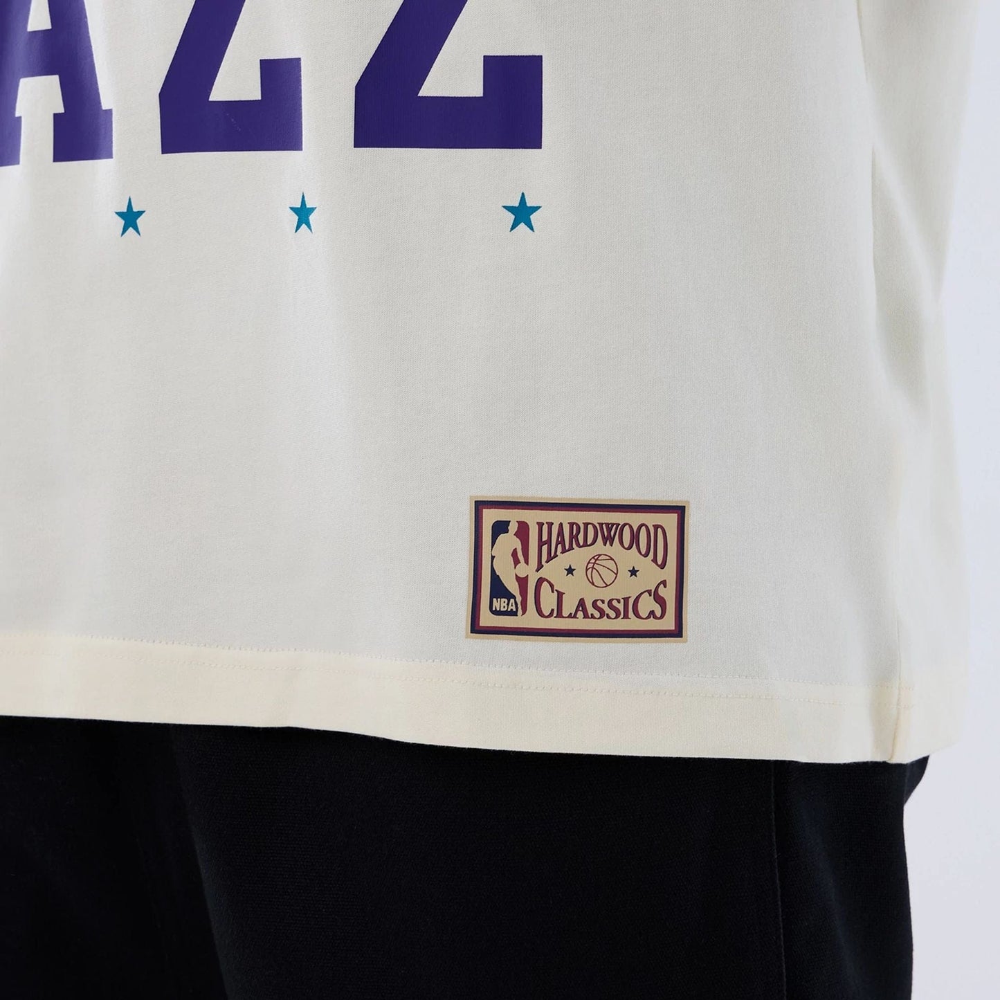 The model is wearing this NBA Hardwood Classic Utah Jazz T-Shirt in Cream. 5