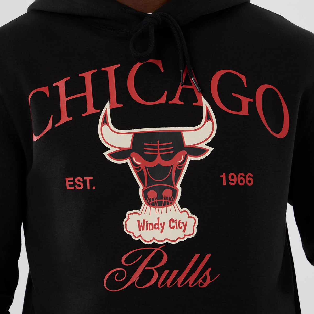 New Era Chicago Bulls NBA Hardwood Classic Black Pullover Hoodie, front view showing a large printed graphic of the Bulls logo with Chicago in red above and Windy City in white below, set against the black fabric.
