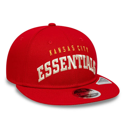 Kansas City Chiefs Fear Of God x NFL Red Retro Crown New Era 9FIFTY Adjustable Cap, three-quarter view showing large white raised ESSENTIALS embroidery on the front, with KANSAS CITY in smaller gold lettering above.
