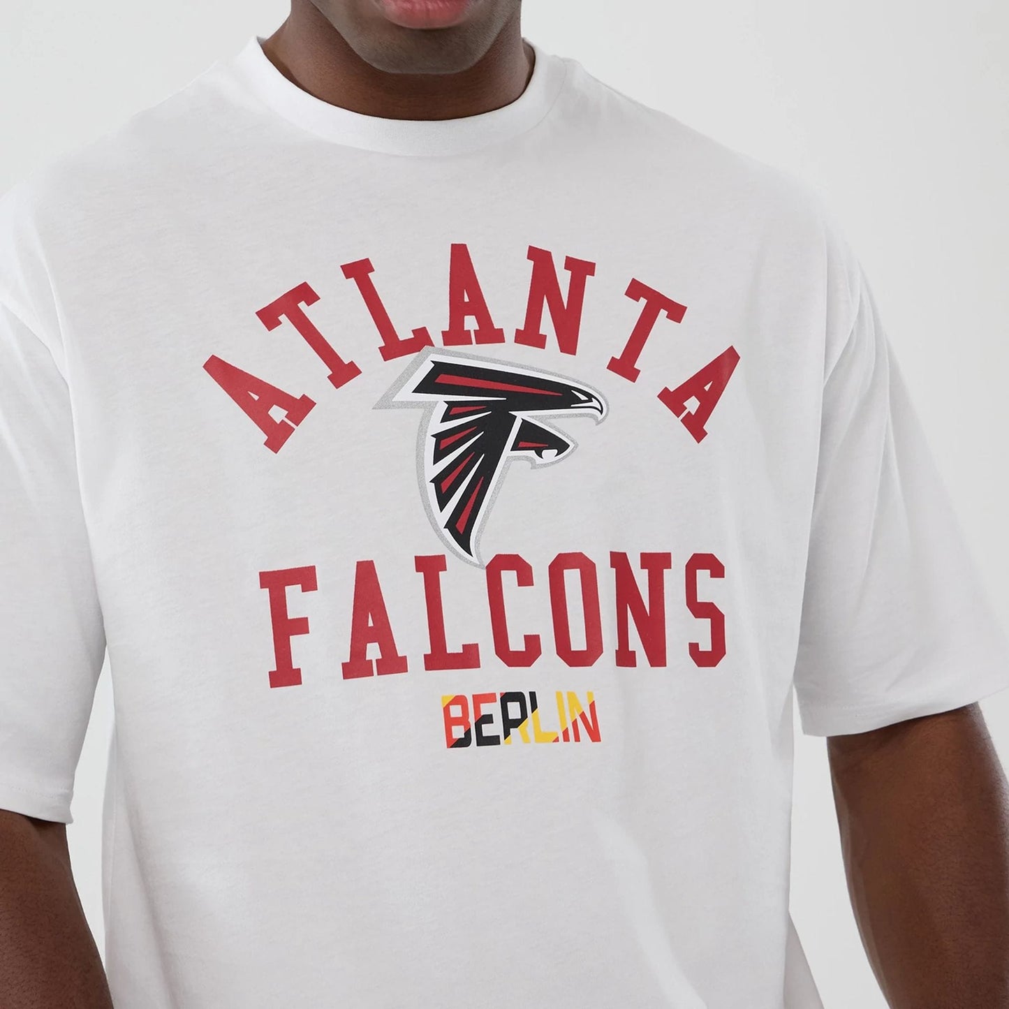 The Male model is wearing Atlanta Falcons NFL International Series Games 2025 White Oversized T-Shirt  3