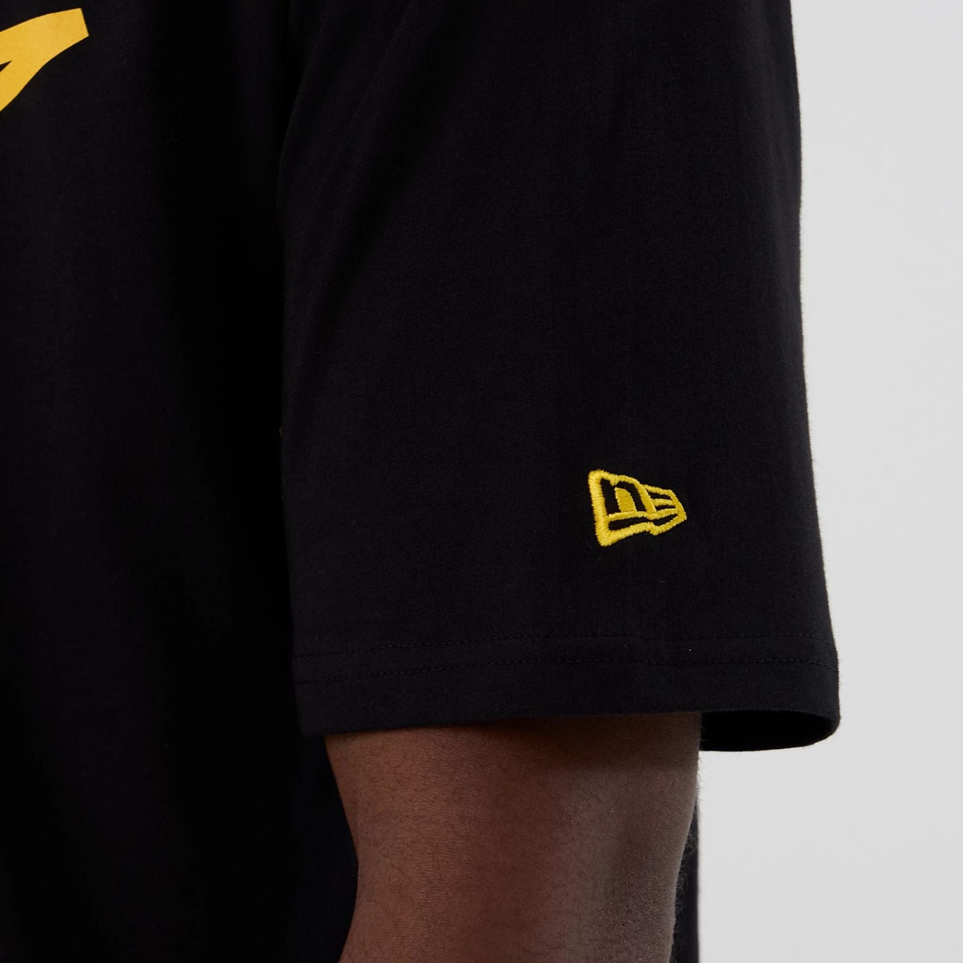 The Male model is wearing Minnesota Vikings NFL International Series Games 2025 Black Oversized T-Shirt  6