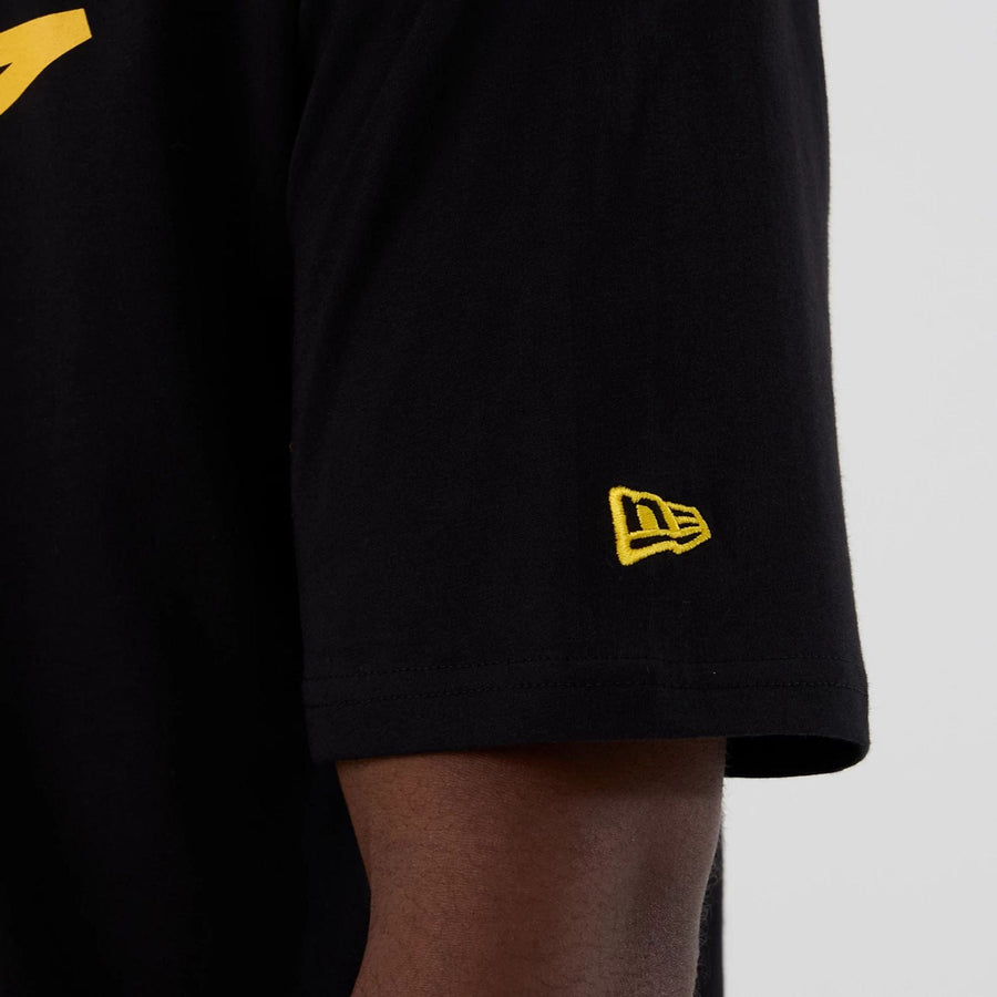 The Male model is wearing Minnesota Vikings NFL International Series Games 2025 Black Oversized T-Shirt  6