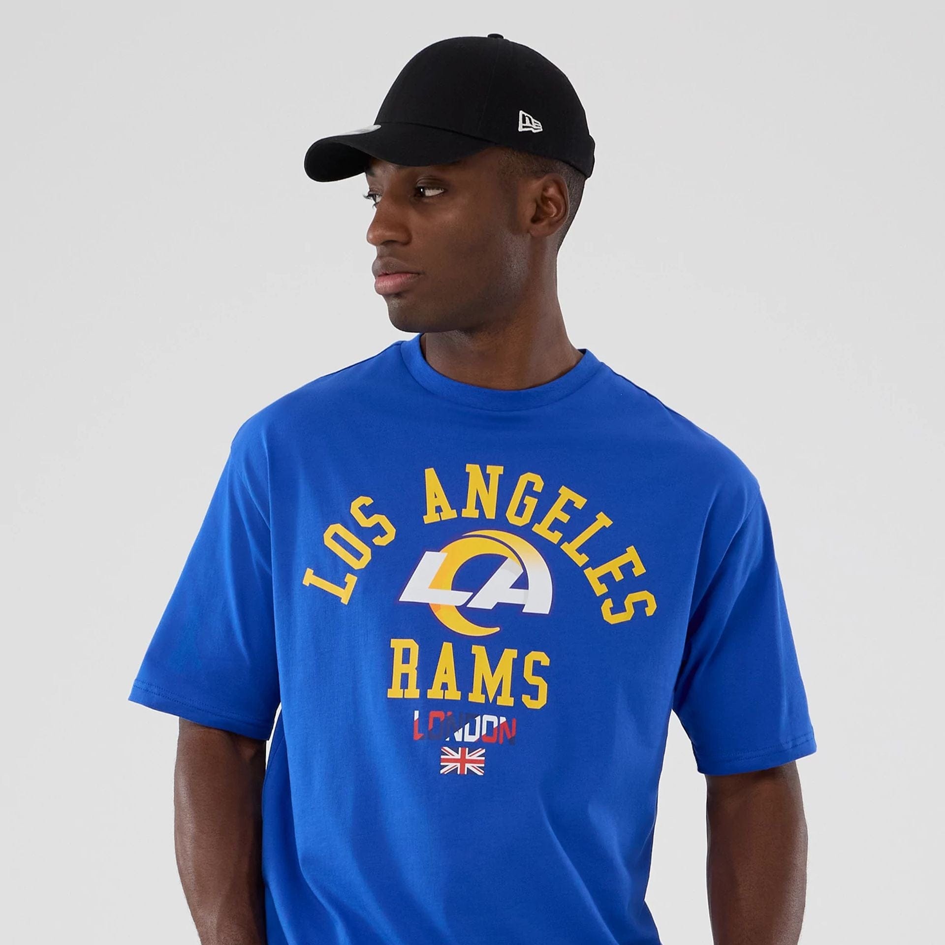 The Male model is wearing LA Rams NFL International Series Games 2025 Bright Blue Oversized T-Shirt  7