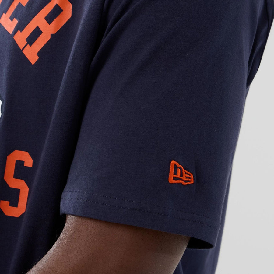 The Male model is wearing Denver Broncos NFL International Series Games 2025 Navy Oversized T-Shirt  6