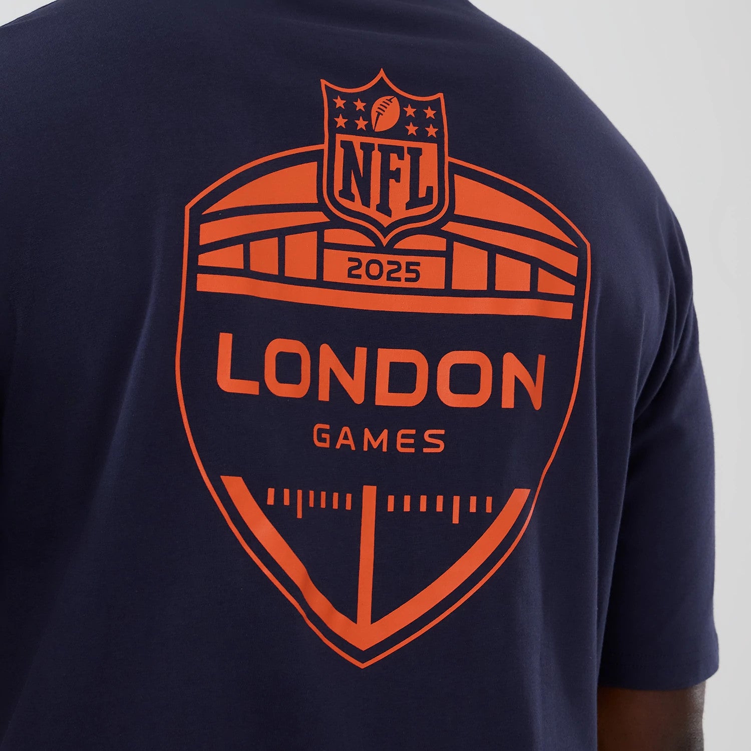 The Male model is wearing Denver Broncos NFL International Series Games 2025 Navy Oversized T-Shirt 4