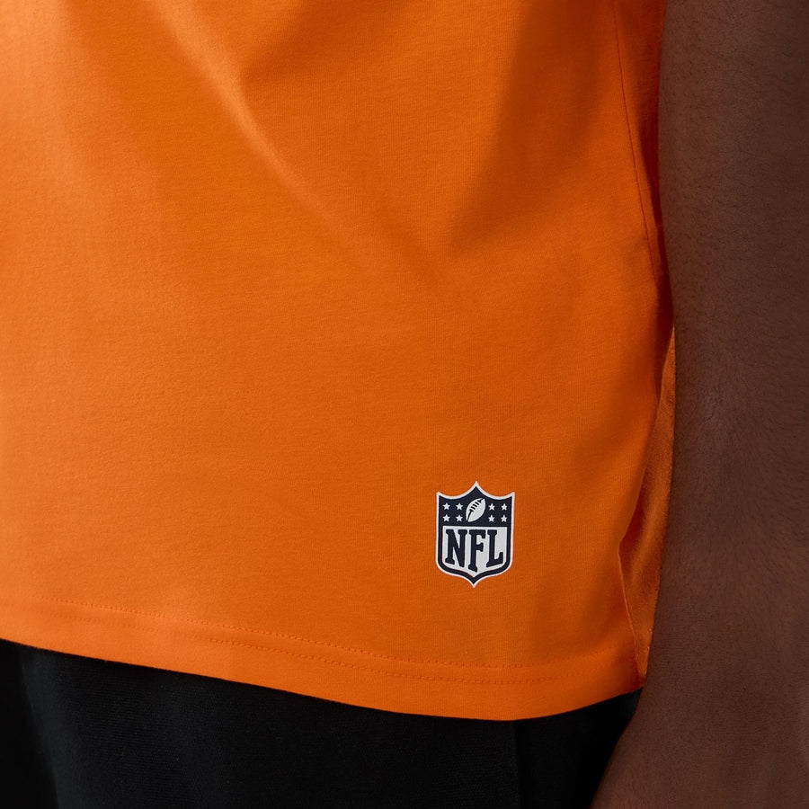 The Male model is wearing Denver Broncos NFL International Series Games 2025 Orange Oversized T-Shirt  5