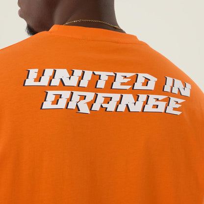 The Male model is wearing Denver Broncos NFL International Series Games 2025 Orange Oversized T-Shirt  6