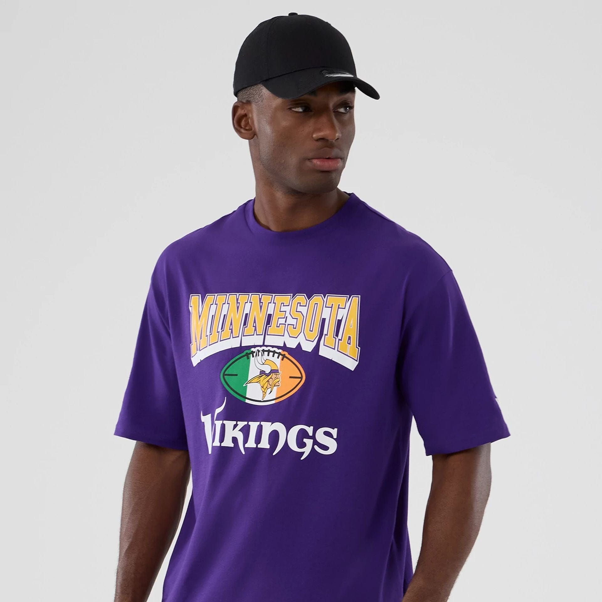 The Male model is wearing Minnesota Vikings NFL International Series Games 2025 Purple Oversized T-Shirt  3