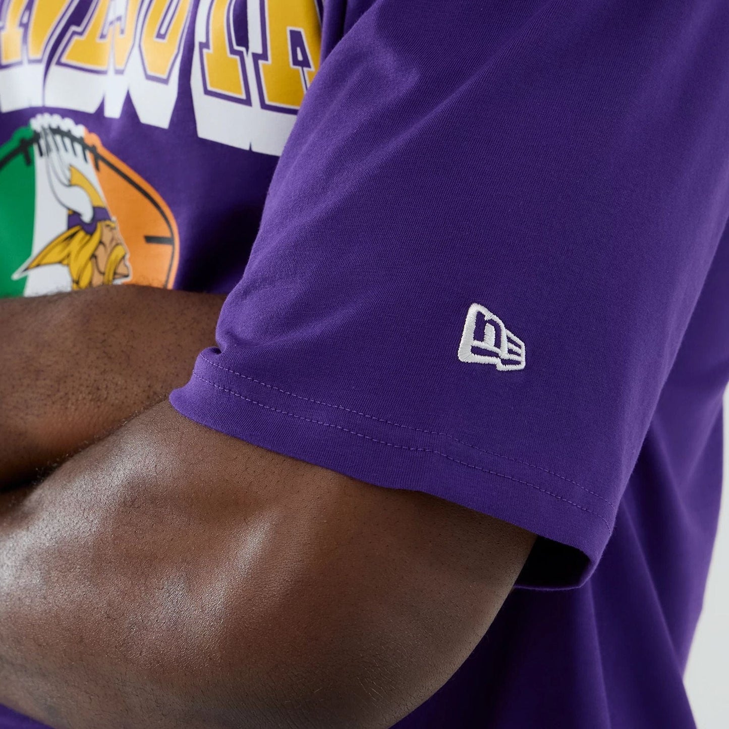 The Male model is wearing Minnesota Vikings NFL International Series Games 2025 Purple Oversized T-Shirt  7