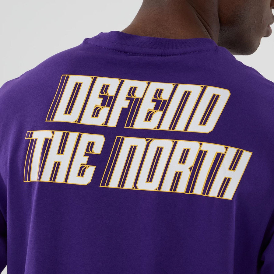 The Male model is wearing Minnesota Vikings NFL International Series Games 2025 Purple Oversized T-Shirt  6