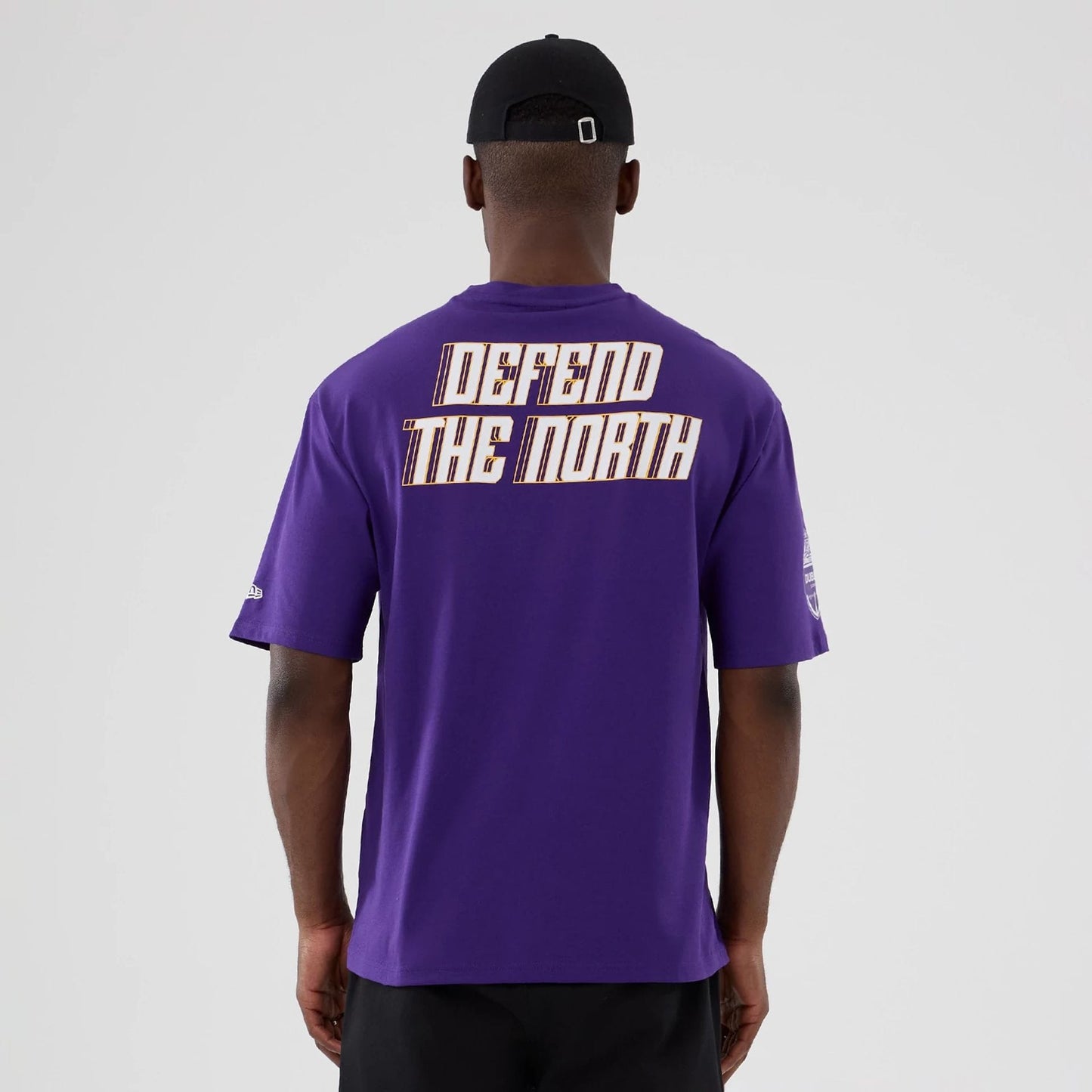 The Male model is wearing Minnesota Vikings NFL International Series Games 2025 Purple Oversized T-Shirt  2