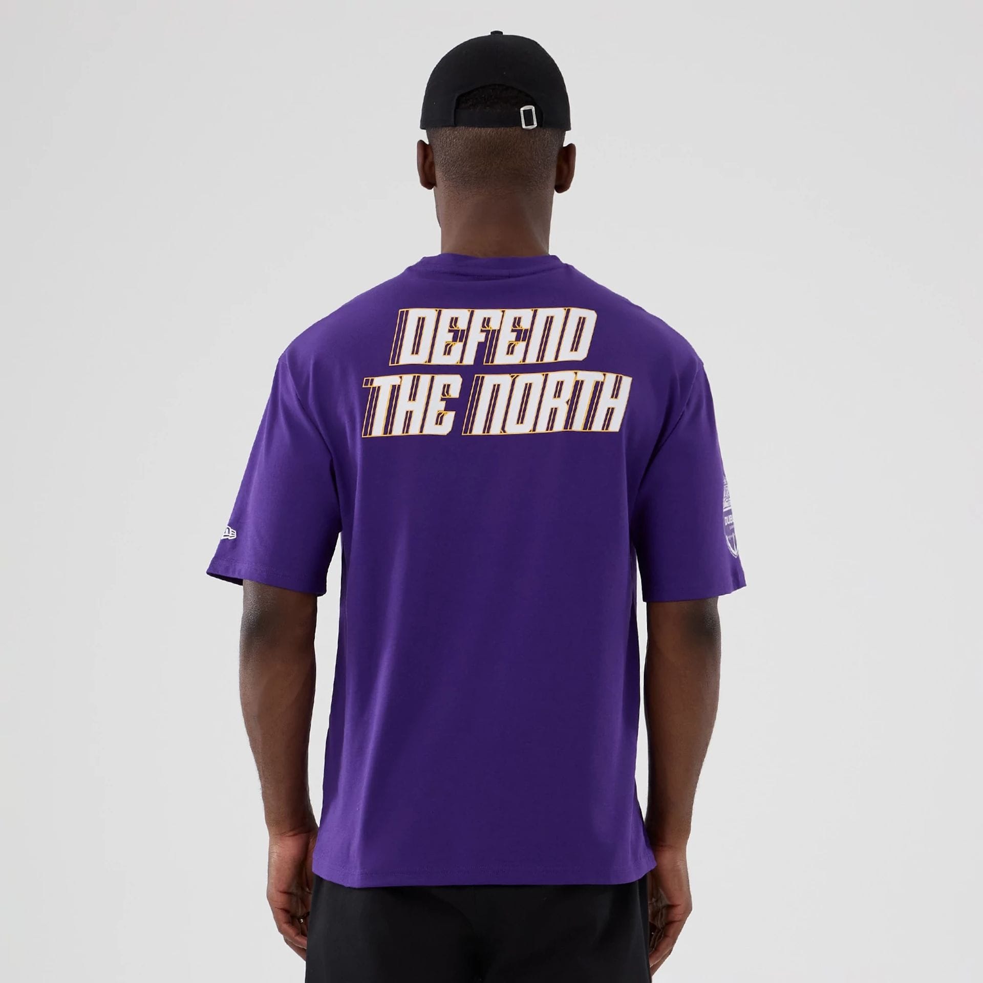 The Male model is wearing Minnesota Vikings NFL International Series Games 2025 Purple Oversized T-Shirt  2
